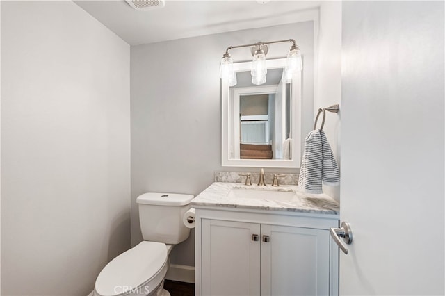 bathroom featuring vanity and toilet