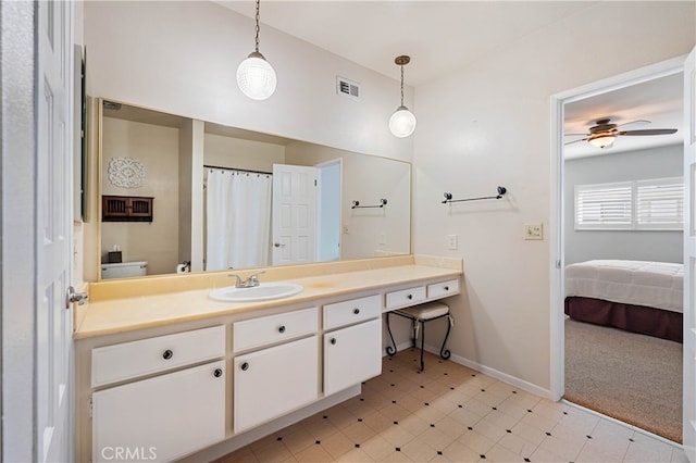 bathroom featuring vanity, ceiling fan, and toilet