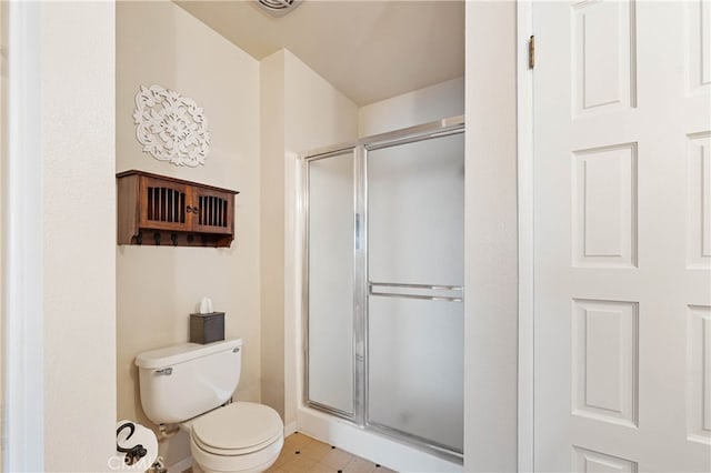 bathroom with toilet and a shower with shower door