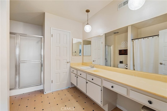 bathroom with vanity and a shower