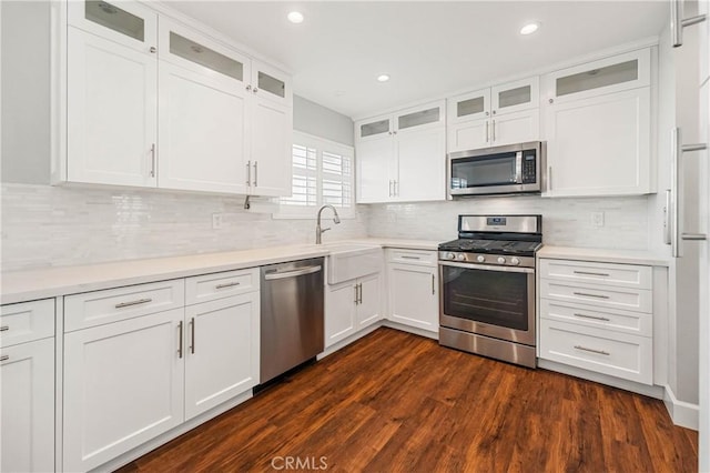 kitchen featuring sink, dark hardwood / wood-style floors, white cabinets, and appliances with stainless steel finishes