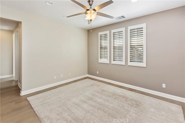 empty room featuring ceiling fan and light hardwood / wood-style flooring