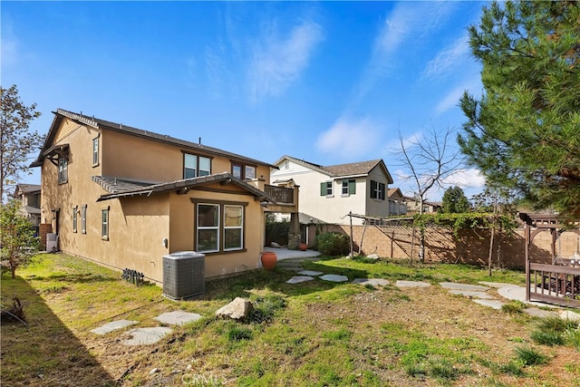 back of property featuring a yard and central AC unit