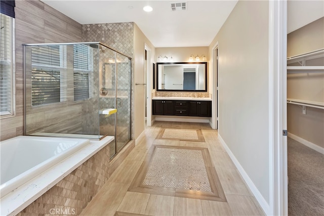 bathroom with vanity and plus walk in shower