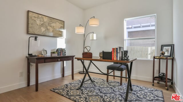 office space with wood-type flooring