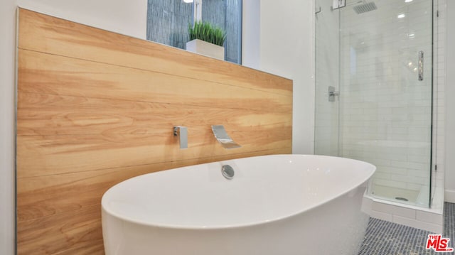 bathroom featuring shower with separate bathtub and tile patterned floors