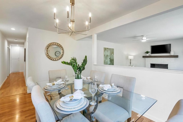 dining area with light hardwood / wood-style floors and ceiling fan