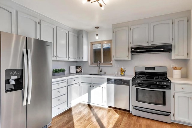 kitchen featuring white cabinetry, appliances with stainless steel finishes, sink, and light wood-type flooring