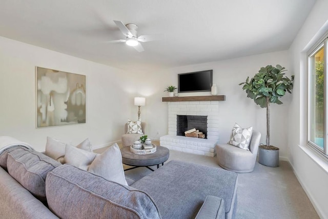 living room with a fireplace, ceiling fan, and carpet