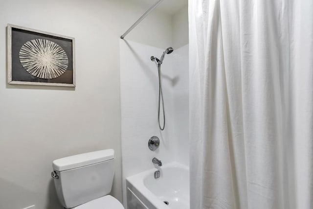 bathroom featuring shower / tub combo with curtain and toilet