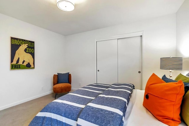 bedroom with carpet and a closet