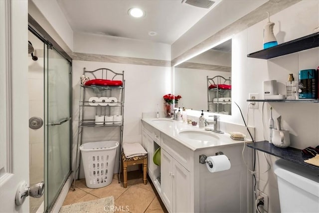 bathroom featuring tile patterned flooring, vanity, an enclosed shower, and toilet