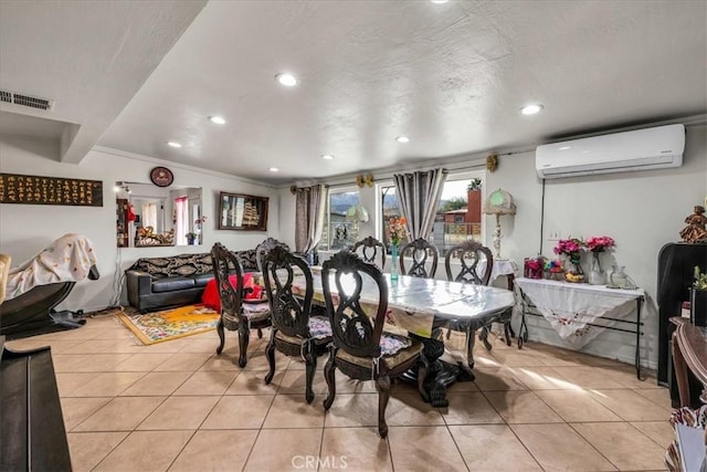 tiled dining area featuring a wall mounted air conditioner, ornamental molding, and a textured ceiling