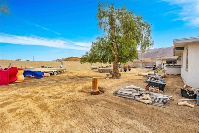 view of yard with a mountain view and a playground