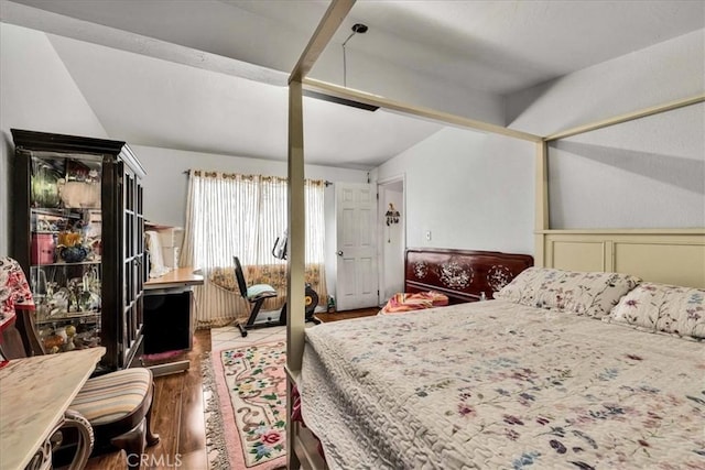 bedroom with lofted ceiling and hardwood / wood-style floors