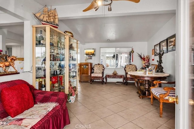 sitting room featuring lofted ceiling, tile patterned flooring, and ceiling fan