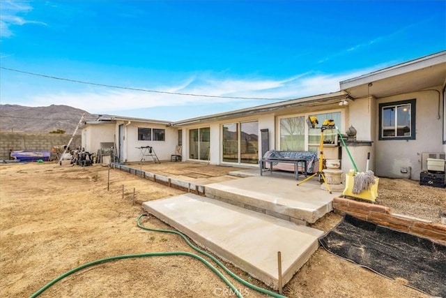 rear view of property featuring a patio and a mountain view