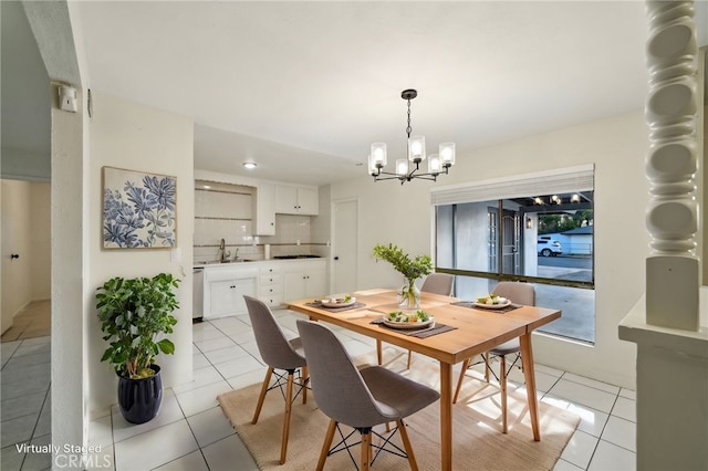 dining space featuring sink, light tile patterned floors, and a chandelier