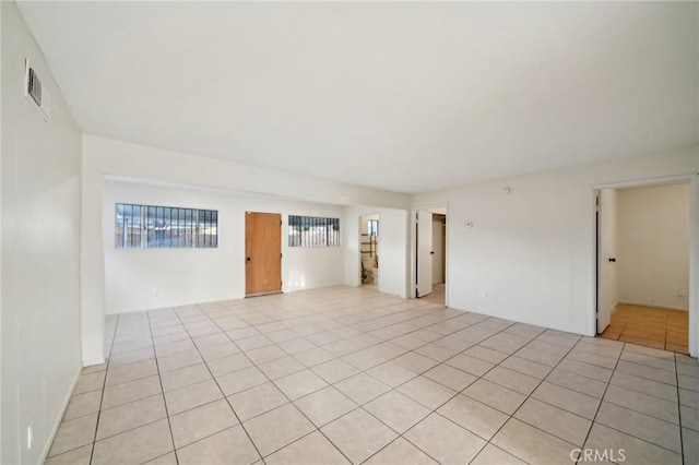 spare room featuring light tile patterned flooring