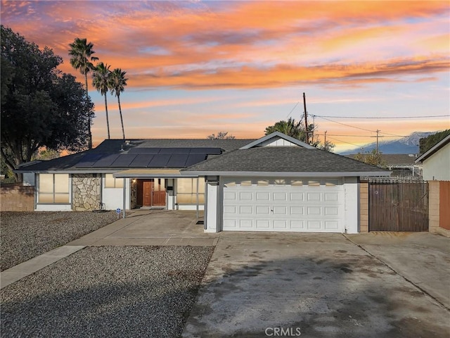 view of front of home featuring a garage and solar panels