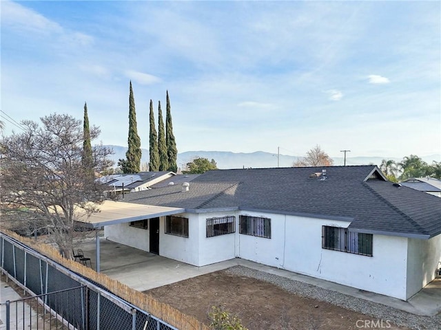 back of property featuring a mountain view