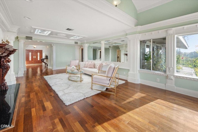 living room with crown molding, dark hardwood / wood-style floors, and ornate columns