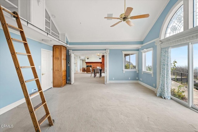 interior space featuring crown molding, high vaulted ceiling, light carpet, and a wealth of natural light