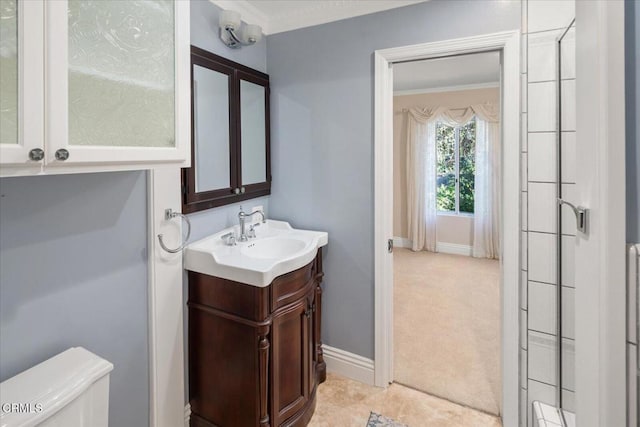 bathroom featuring ornamental molding, vanity, and toilet