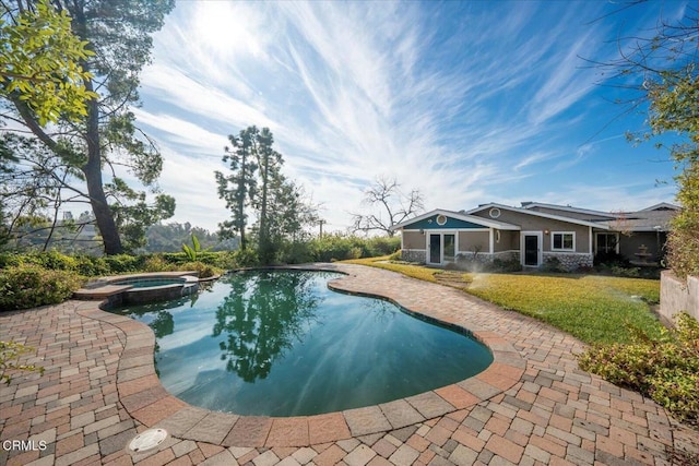 view of swimming pool with a patio area and an in ground hot tub