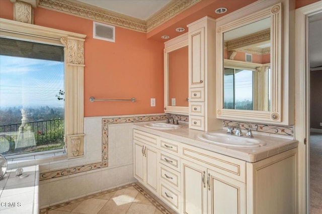 bathroom featuring tile patterned flooring, crown molding, tile walls, and vanity