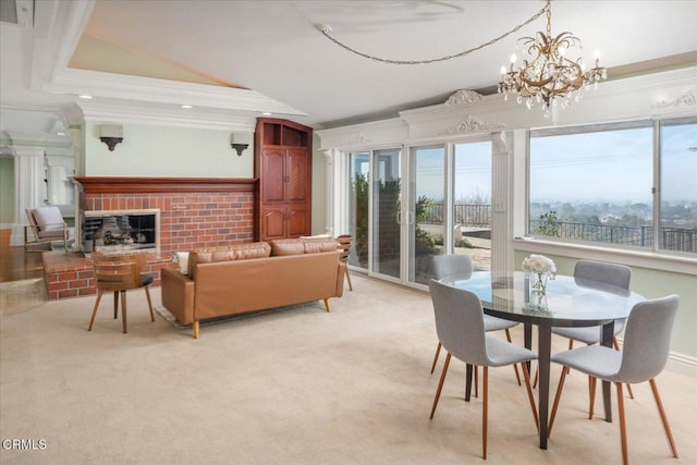 interior space featuring an inviting chandelier, crown molding, a fireplace, and light colored carpet