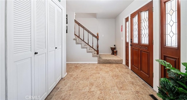 foyer entrance with light tile patterned floors