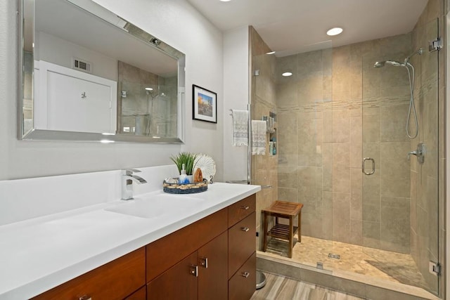 bathroom featuring an enclosed shower and vanity