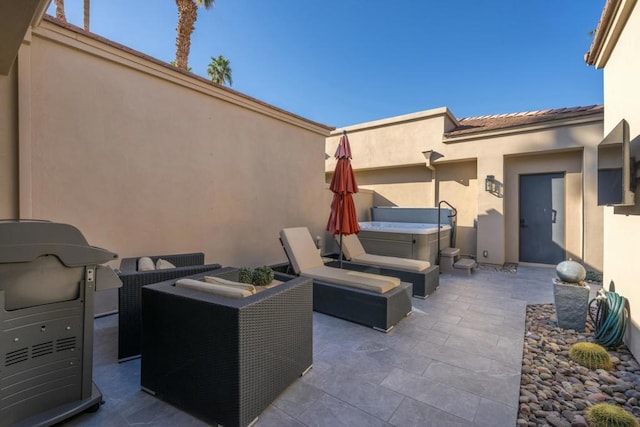 view of patio / terrace with a hot tub