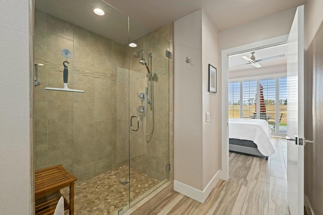 bathroom featuring ceiling fan and walk in shower