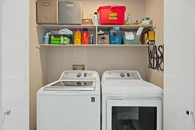 clothes washing area with washing machine and clothes dryer