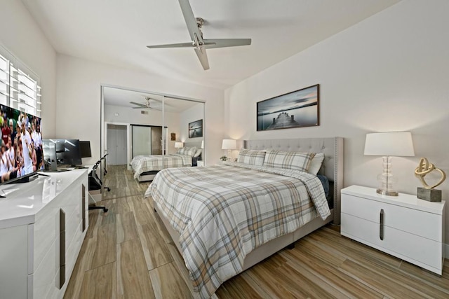 bedroom with a closet, ceiling fan, and light wood-type flooring