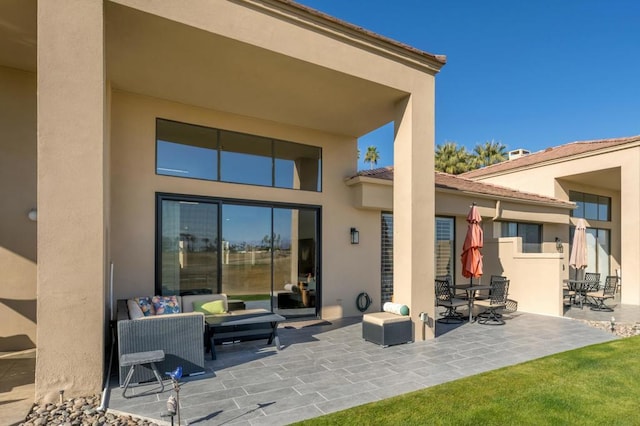 rear view of property featuring a patio area