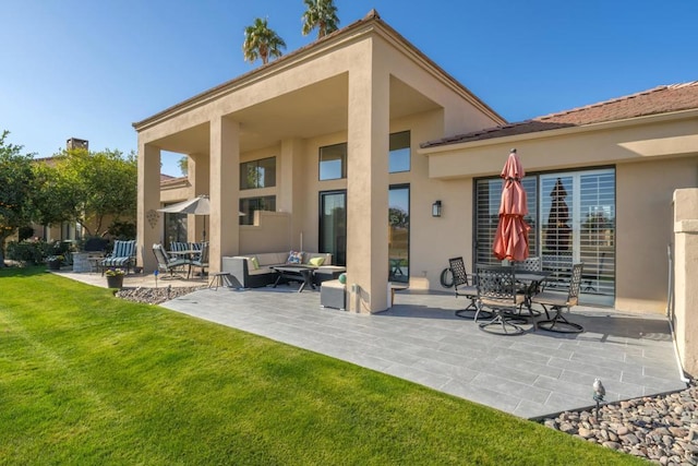 rear view of house featuring a yard, a patio area, and outdoor lounge area