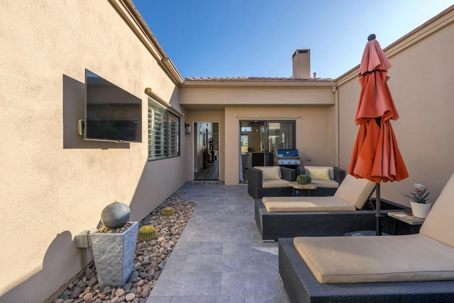 view of patio / terrace with area for grilling and outdoor lounge area