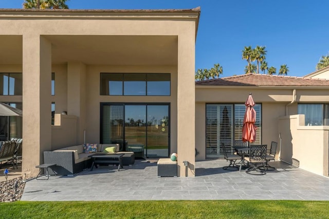 back of property featuring outdoor lounge area and a patio area