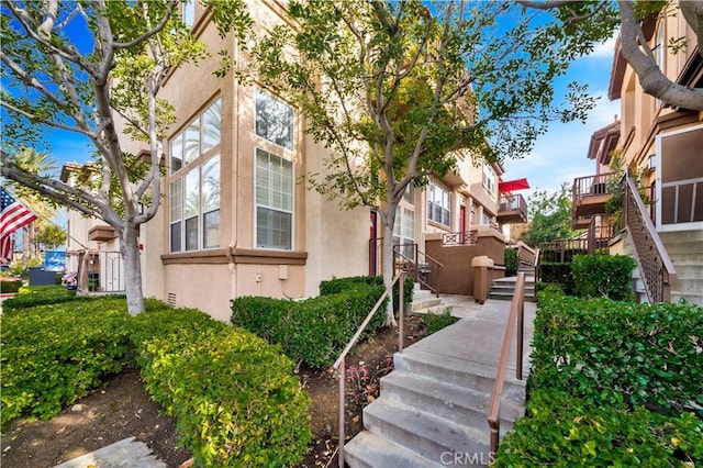 view of property exterior featuring stairway and stucco siding