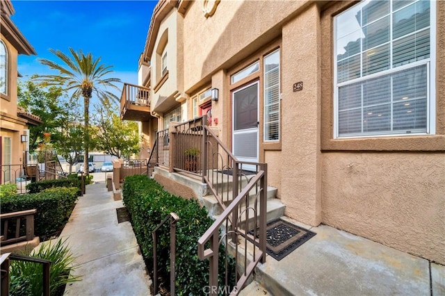 entrance to property with stucco siding