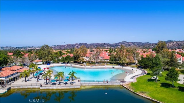 view of swimming pool with a water and mountain view