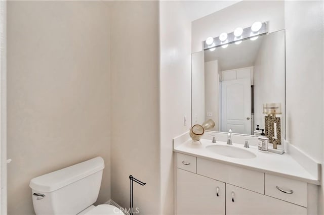 bathroom featuring vanity and toilet