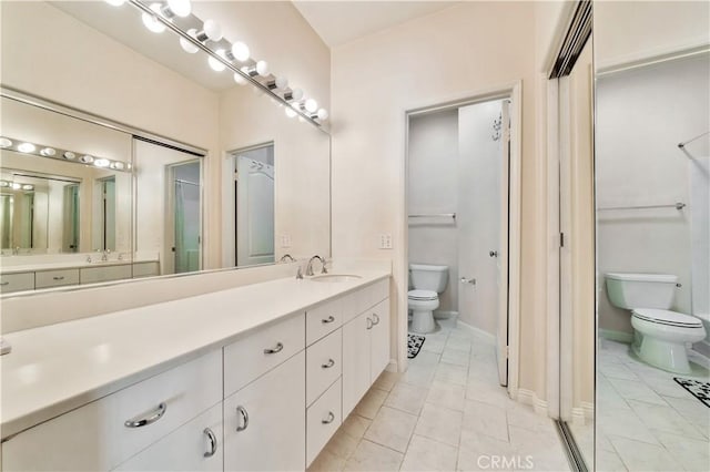 full bathroom featuring vanity, toilet, and baseboards