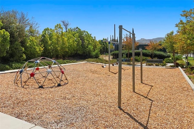 view of jungle gym with a mountain view