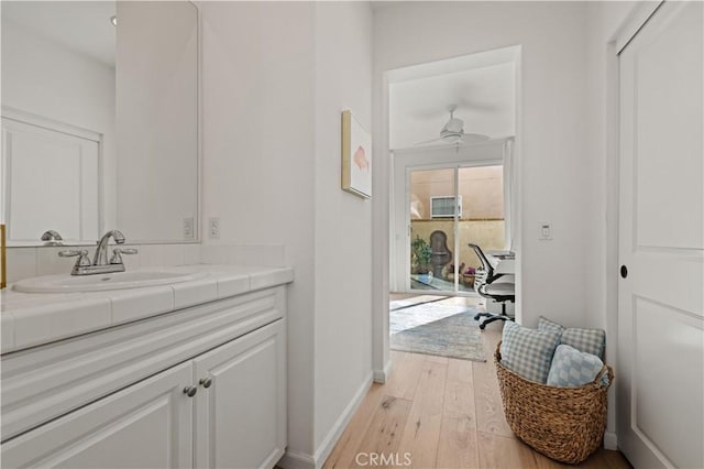 bathroom featuring vanity, hardwood / wood-style floors, and ceiling fan