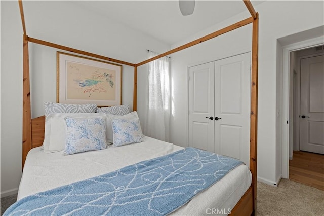 carpeted bedroom featuring ceiling fan and a closet