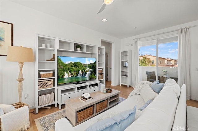 living room featuring ceiling fan and light wood-type flooring